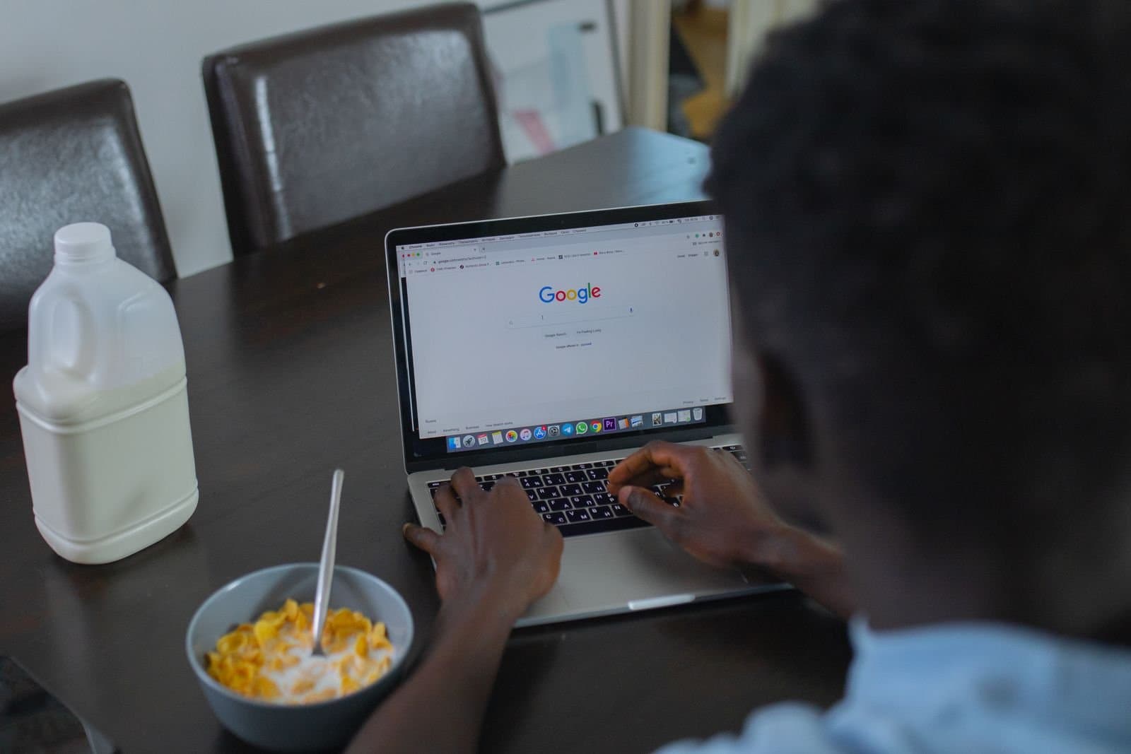 Person using Google search on a laptop, representing local SEO for a dental clinic