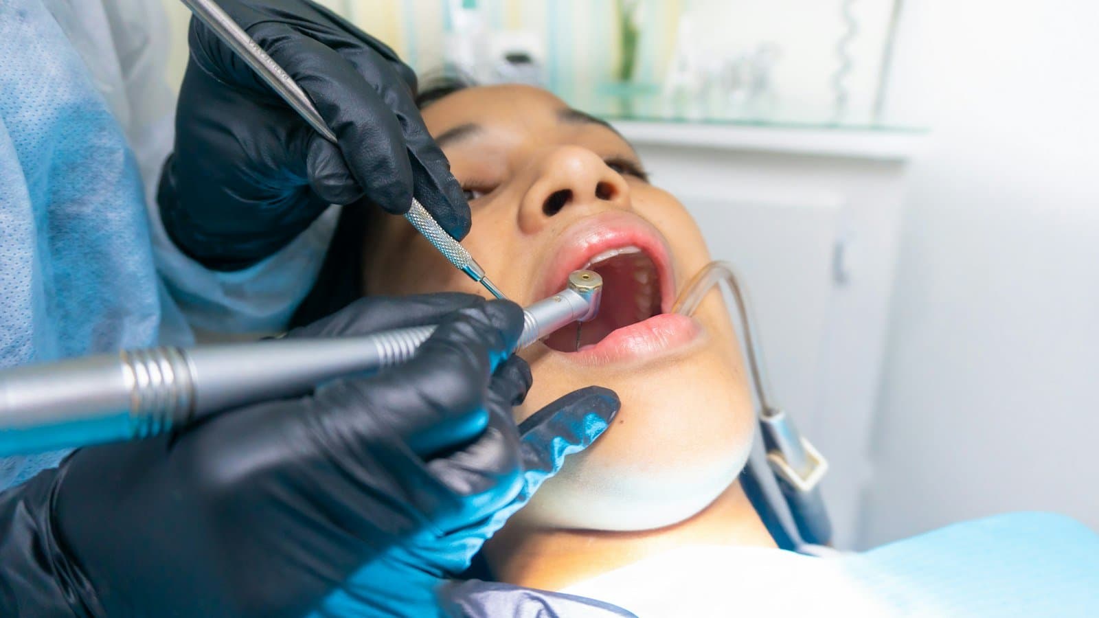 Dental surgical team performing a procedure in a clinical setting