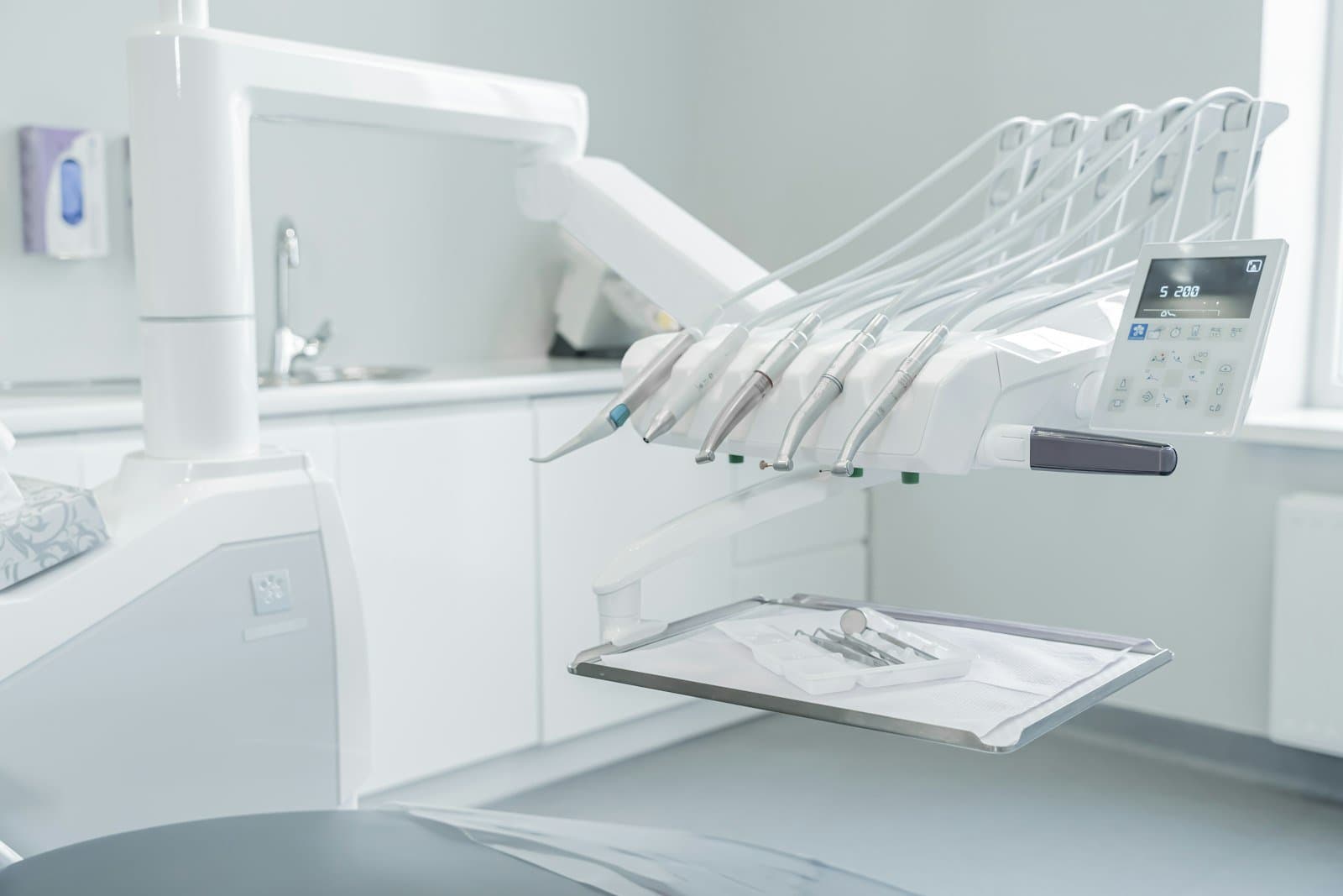 Dental laser light being used on a patient's tooth during a procedure