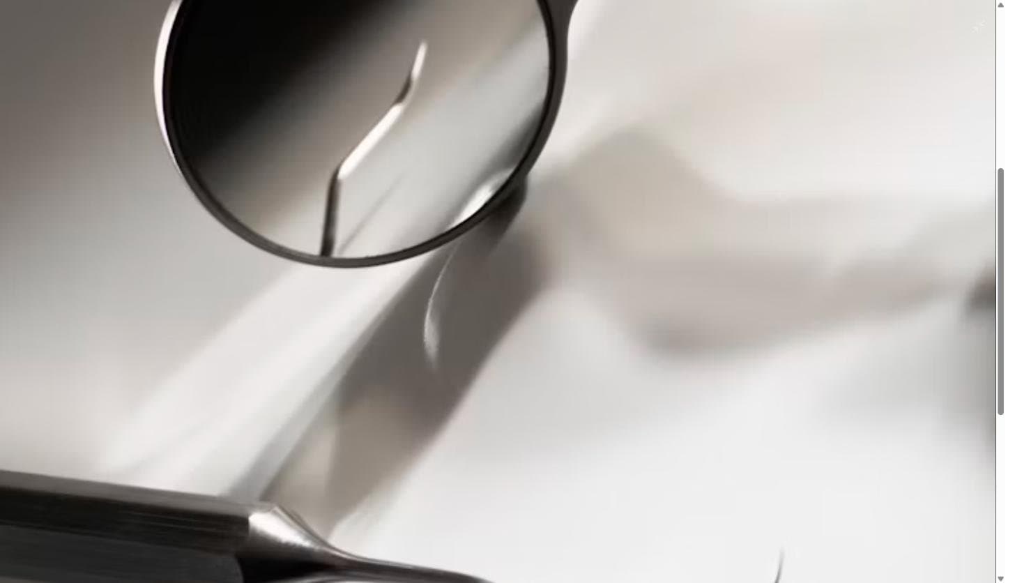 Close-up of dental mirror and probe instruments used during a chairside dental examination
