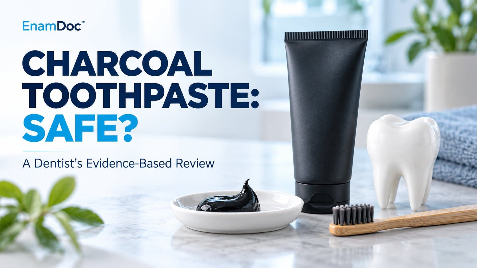 Black toothpaste tube and charcoal paste in a white dish beside a toothbrush and tooth model.